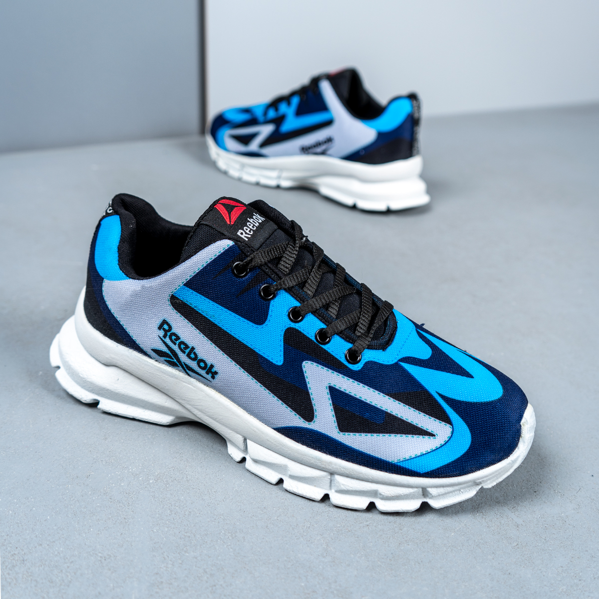 کفش ورزشی ریبوک آبی طوسی مردانه مدل Ervan